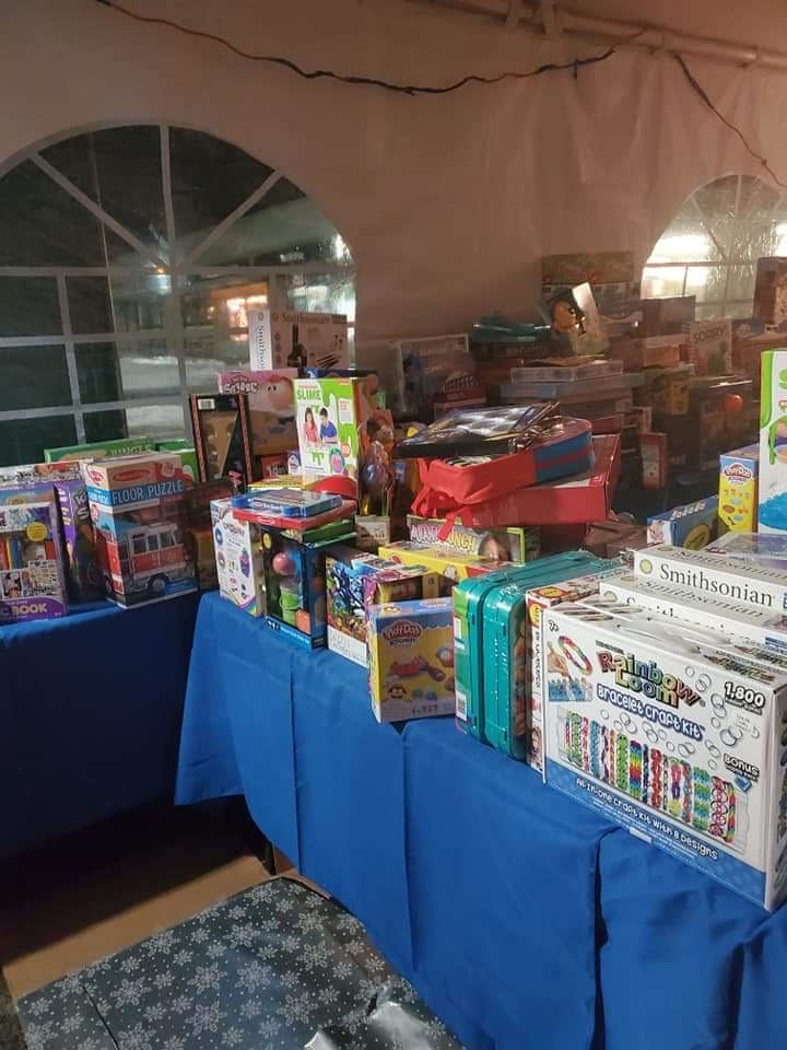 The annual Christmas toy event, put on by Angels of Long Island, allows parents to pick out gifts for their children. Here in the Christmas present tent, gifts are organized by age group and type of toy.